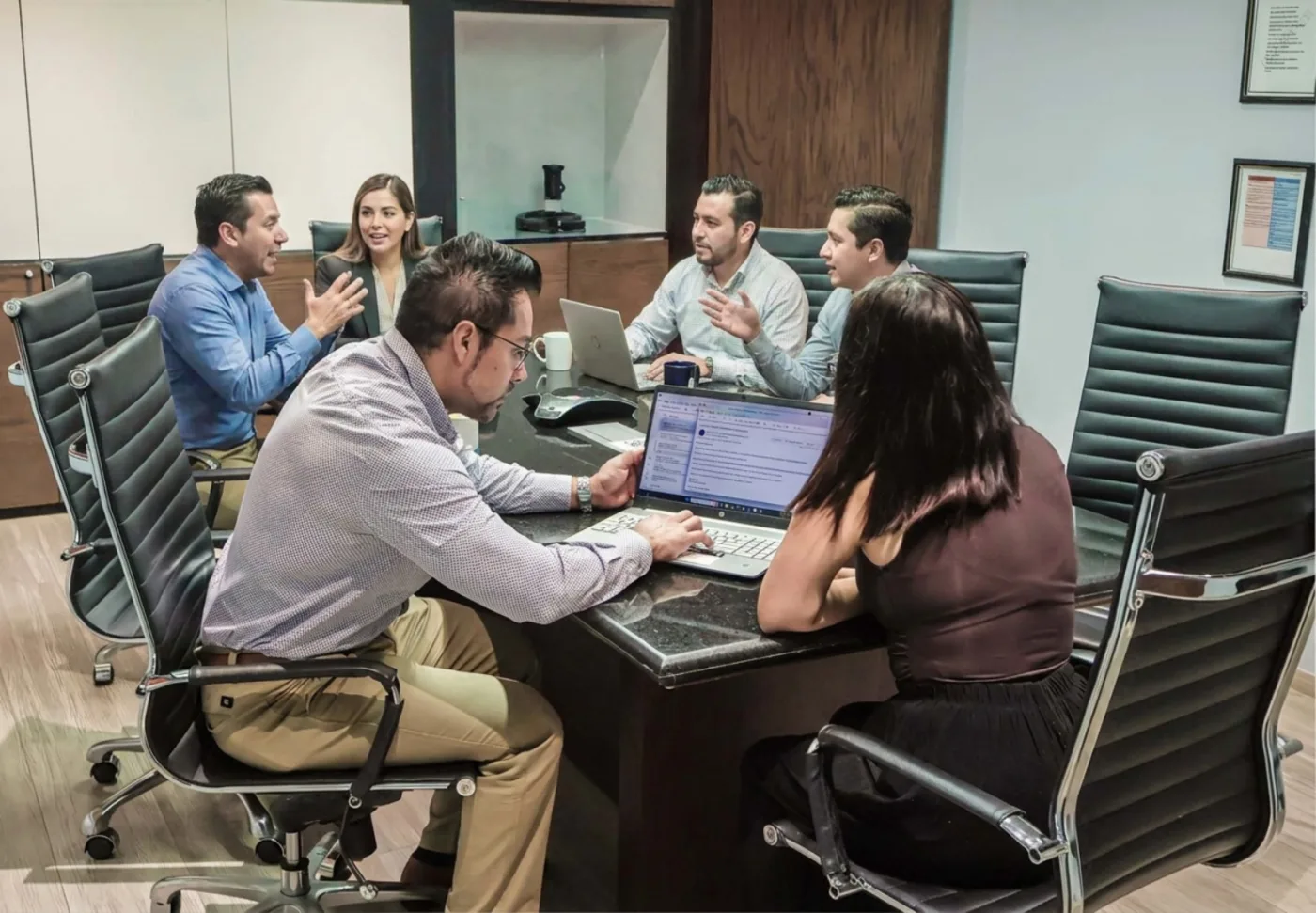 Equipo del despacho revisando informes financieros en sesión de trabajo